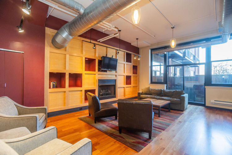 2323 West Pershing Road, Unit 140 Chicago, IL 60609 - Photo 2 of 18 a living room with fireplace furniture and a large window