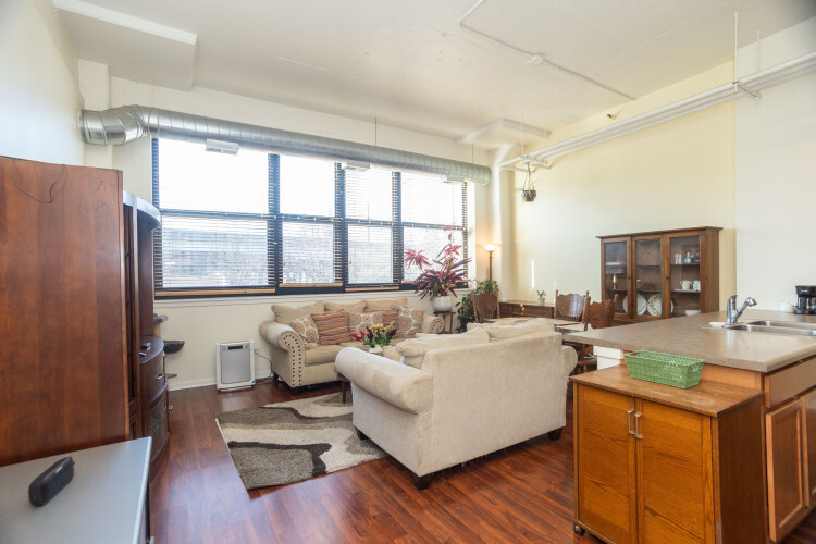 2323 West Pershing Road, Unit 140 Chicago, IL 60609 - Photo 3 of 18 a living room with furniture and a large window