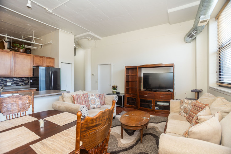 2323 West Pershing Road, Unit 140 Chicago, IL 60609 - Photo 6 of 18 a living room with furniture and a flat screen tv