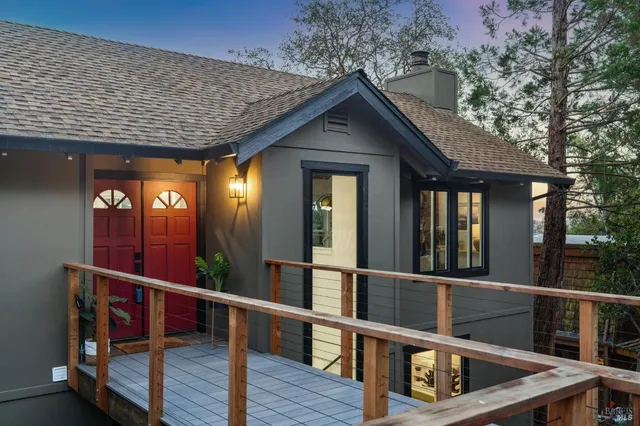 a view of a house with roof deck and furniture