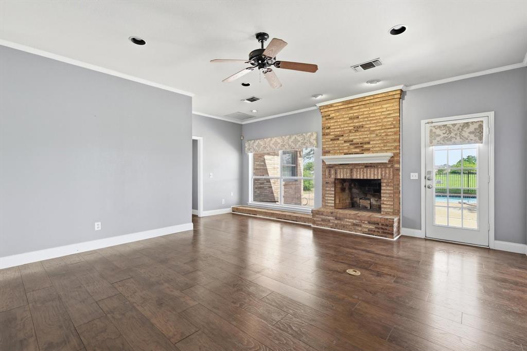 211 Bayne Road Haslet, TX 76052 - Photo 7 of 29 a view of an empty room with wooden floor and a window