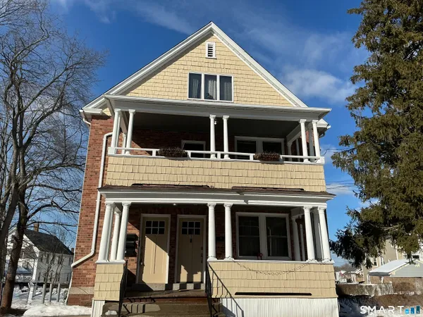 a view of a white house with large windows