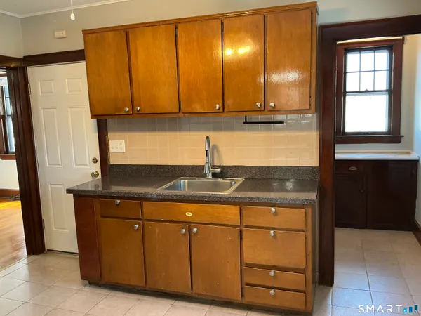 a kitchen with a refrigerator and a sink