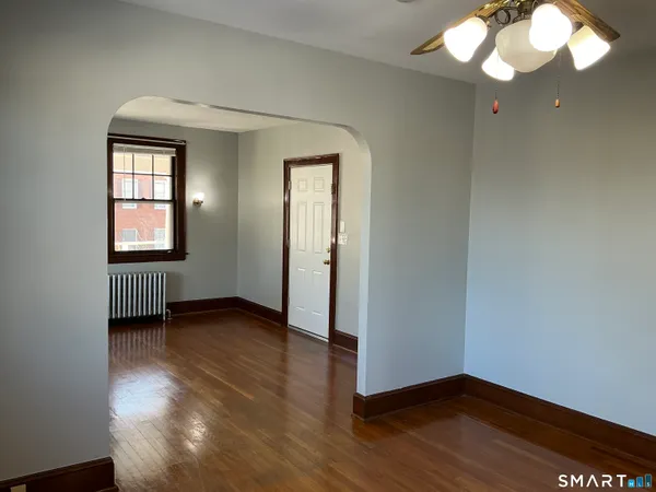 wooden floor in an empty room with a window