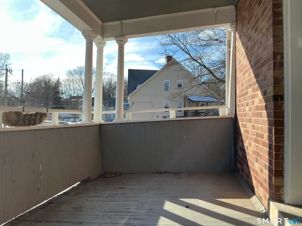 a view of balcony with wooden floor
