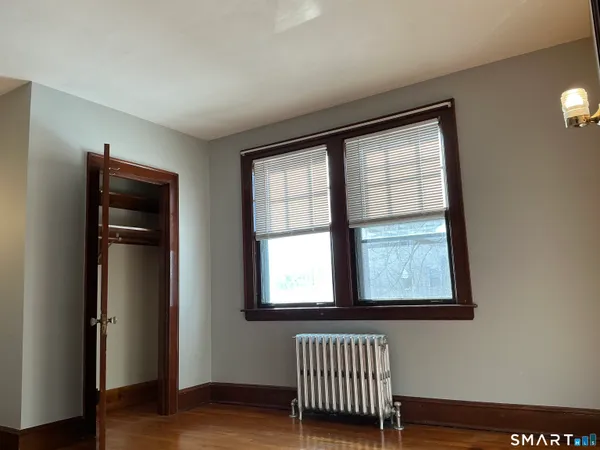 a view of an empty room with wooden floor