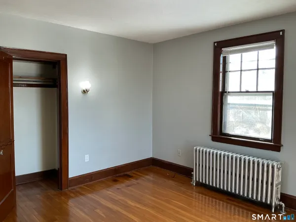 a view of hallway with wooden floor