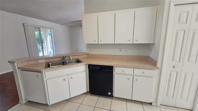 a kitchen with a sink and cabinets