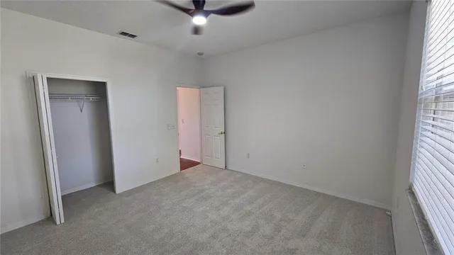 an empty room with a empty space and windows