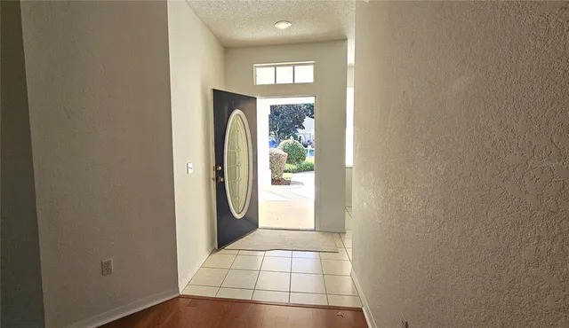 a view of a hallway with windows and entryway
