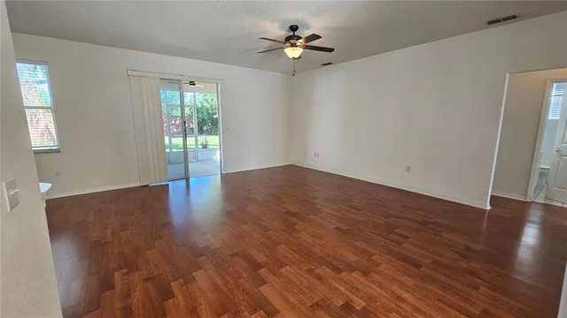 wooden floor in an empty room with a window