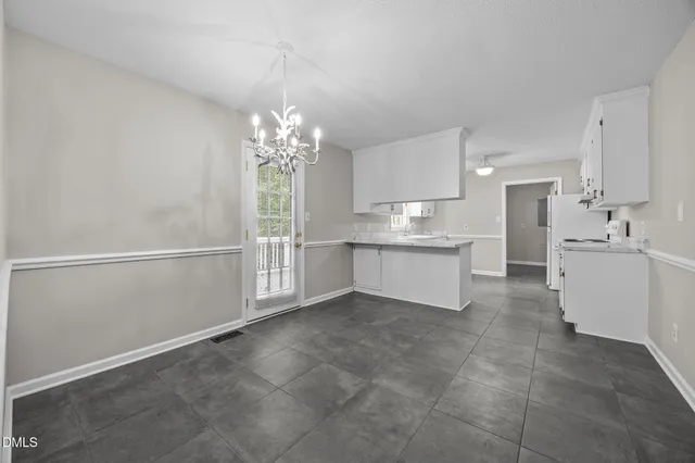 a view of a kitchen with electric appliances