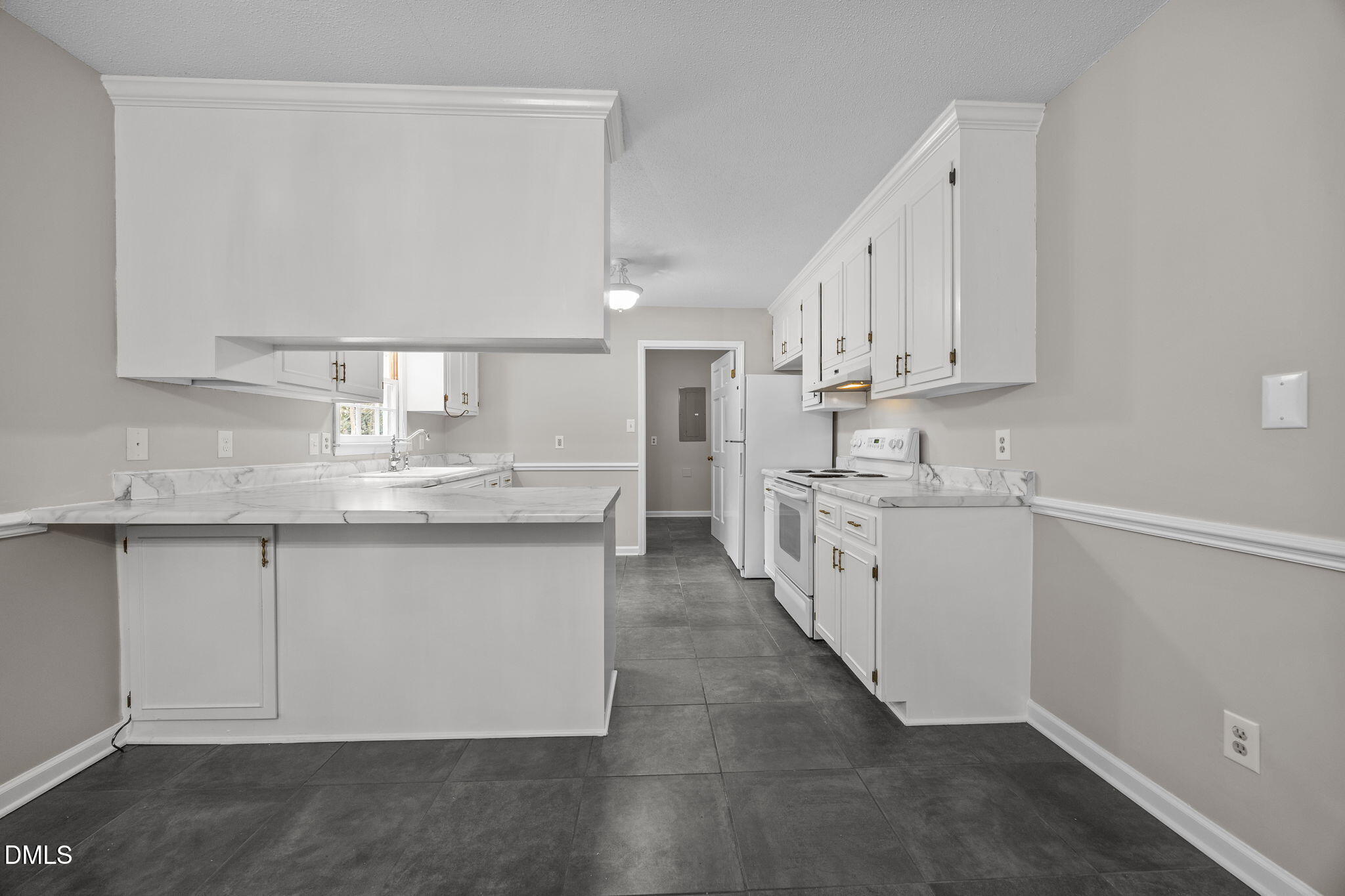 8405 Bells Lake Road Apex, NC 27539 - Photo 12 of 44 a kitchen with granite countertop white cabinets and white appliances