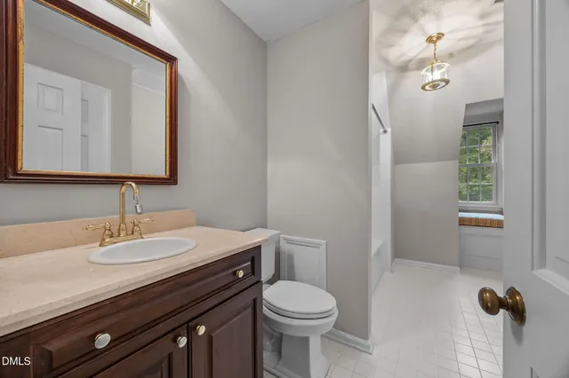 a bathroom with a sink a toilet and a mirror