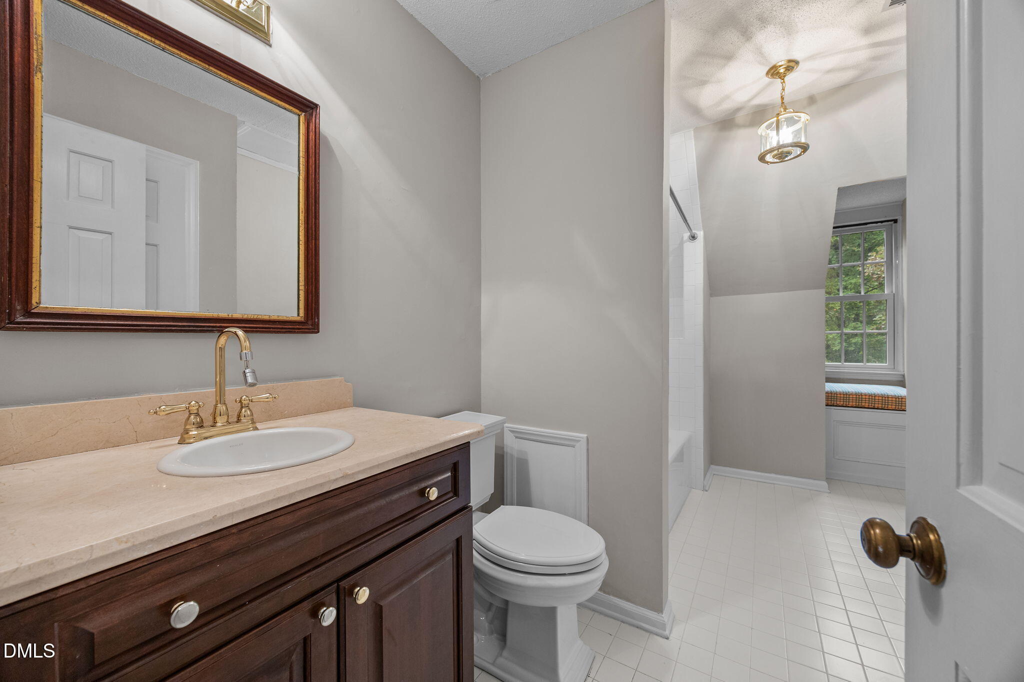 8405 Bells Lake Road Apex, NC 27539 - Photo 24 of 44 a bathroom with a sink a toilet and a mirror