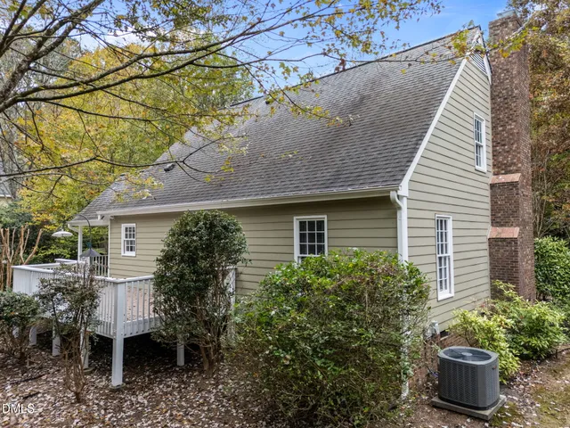 a view of a house with a yard and potted plants