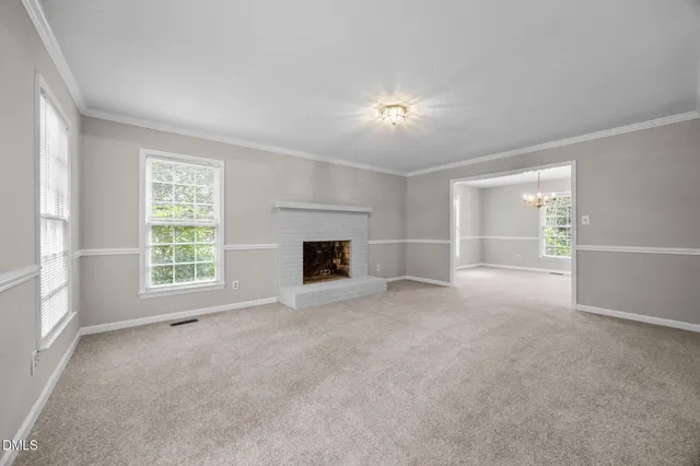 a view of empty room with a fireplace