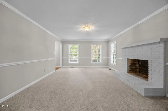 a view of empty room with a fireplace