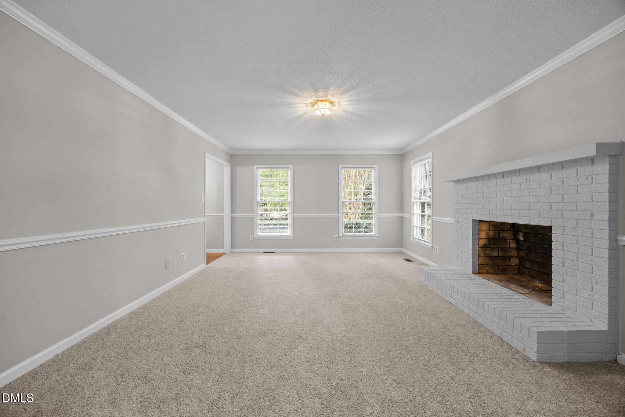 8405 Bells Lake Road Apex, NC 27539 - Photo 7 of 44 a view of empty room with a fireplace