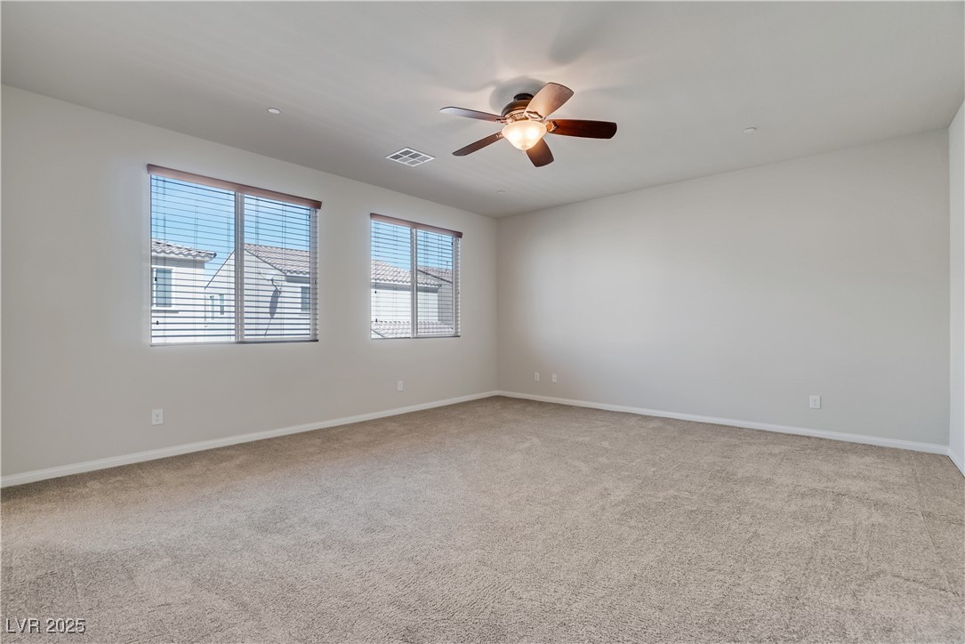 1145 Strada Pecei Henderson, NV 89011 - Photo 19 of 61 Carpeted spare room with ceiling fan and baseboards