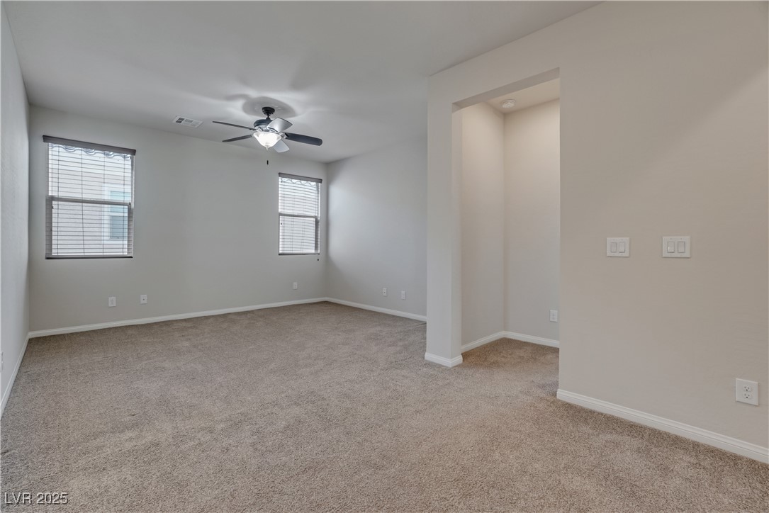 1145 Strada Pecei Henderson, NV 89011 - Photo 21 of 61 Empty room featuring carpet flooring and a ceiling fan