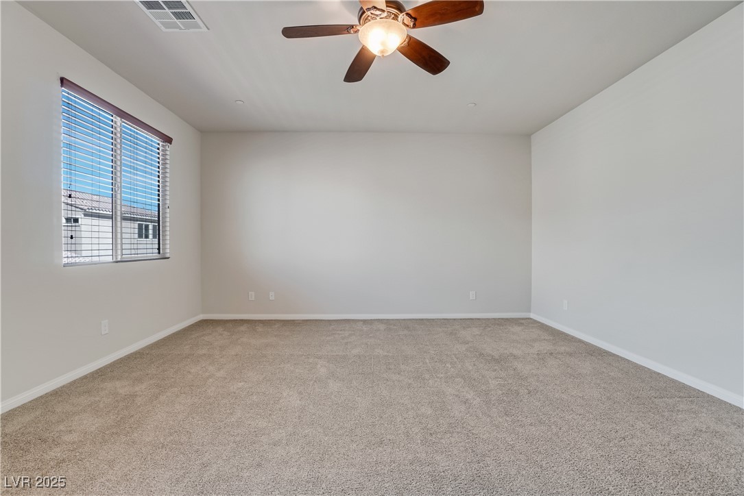 1145 Strada Pecei Henderson, NV 89011 - Photo 22 of 61 Unfurnished room with carpet floors and a ceiling fan