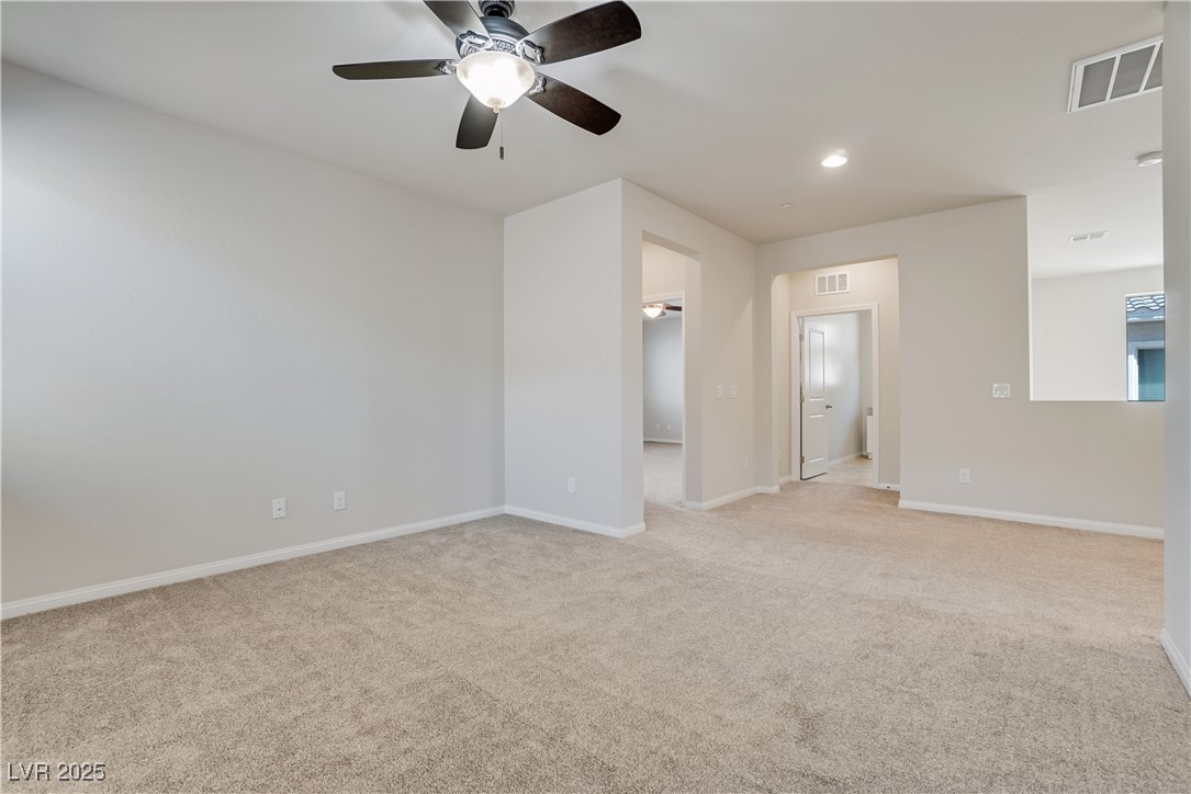 1145 Strada Pecei Henderson, NV 89011 - Photo 23 of 61 Unfurnished room with light carpet, ceiling fan, and recessed lighting