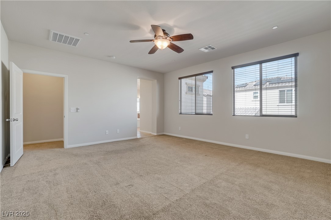 1145 Strada Pecei Henderson, NV 89011 - Photo 24 of 61 Unfurnished room with light colored carpet and a ceiling fan