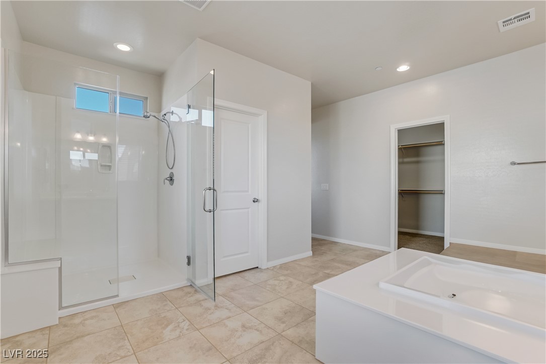 1145 Strada Pecei Henderson, NV 89011 - Photo 27 of 61 Bathroom featuring a shower stall, recessed lighting, and a walk in closet