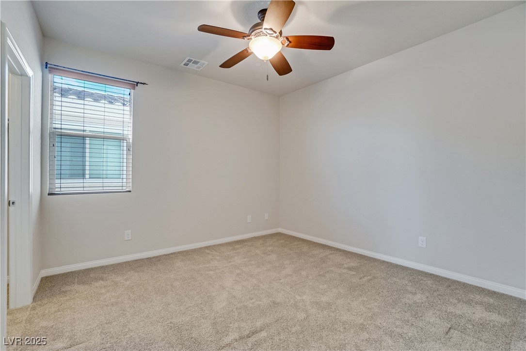 1145 Strada Pecei Henderson, NV 89011 - Photo 31 of 61 Carpeted spare room with ceiling fan and baseboards