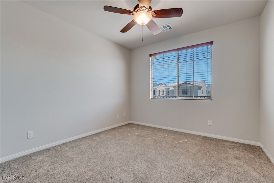 1145 Strada Pecei Henderson, NV 89011 - Photo 33 of 61 Carpeted empty room with baseboards and ceiling fan