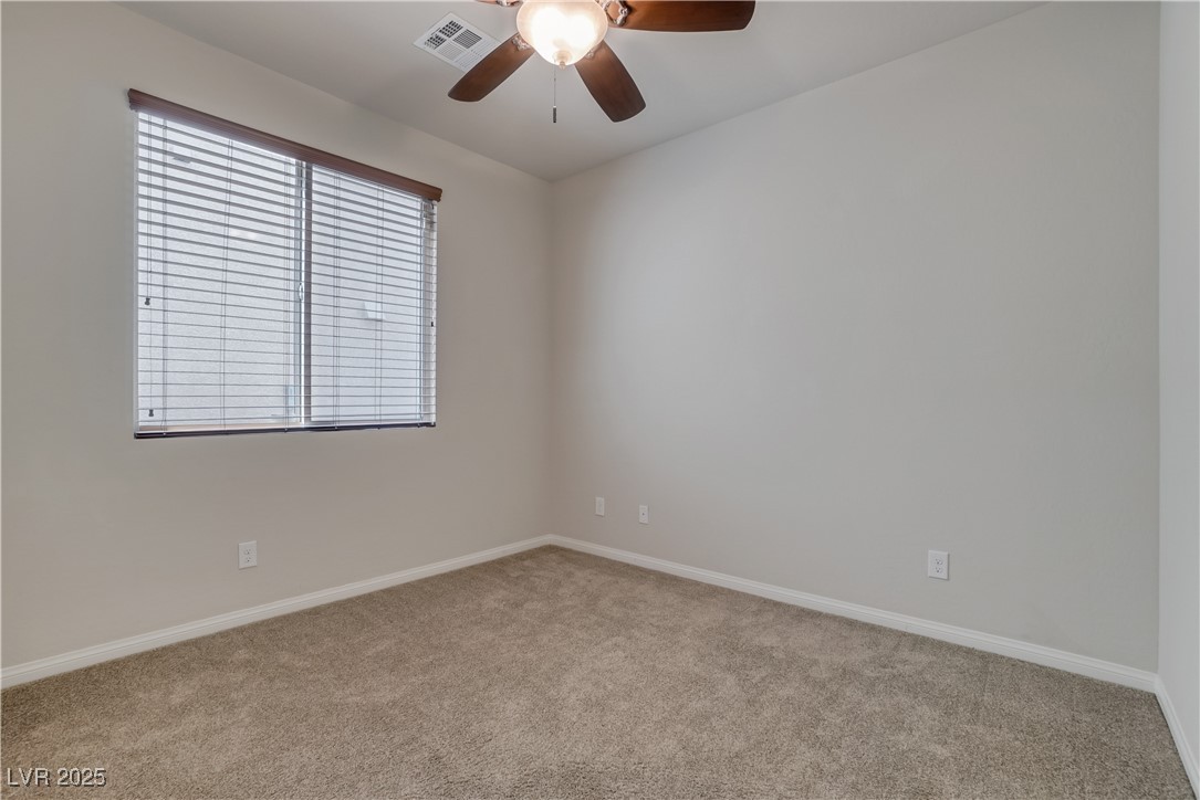 1145 Strada Pecei Henderson, NV 89011 - Photo 34 of 61 Empty room with carpet floors and ceiling fan
