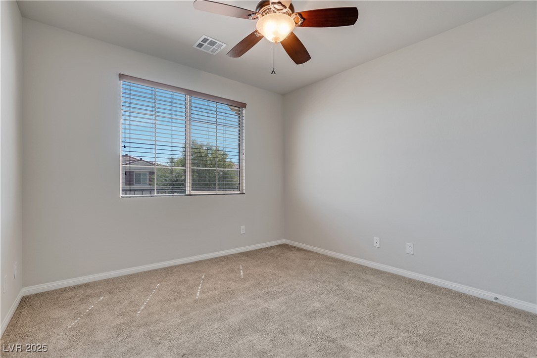 1145 Strada Pecei Henderson, NV 89011 - Photo 35 of 61 Carpeted spare room with baseboards and ceiling fan