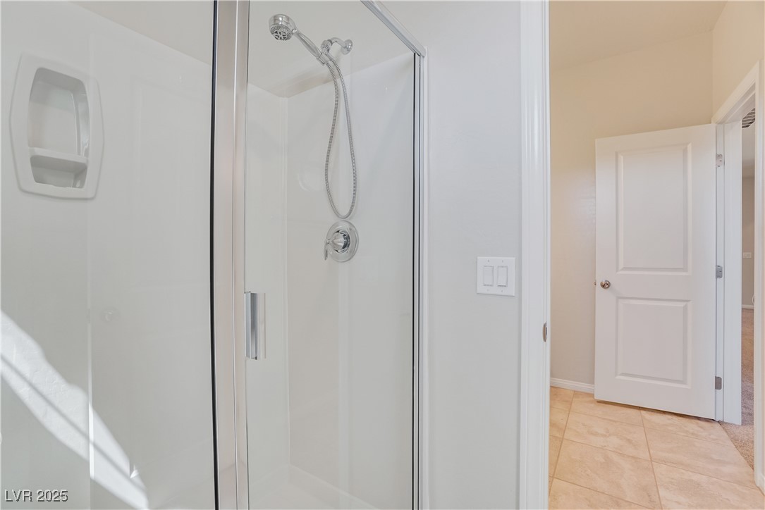 1145 Strada Pecei Henderson, NV 89011 - Photo 37 of 61 Full bathroom featuring a stall shower and tile patterned flooring