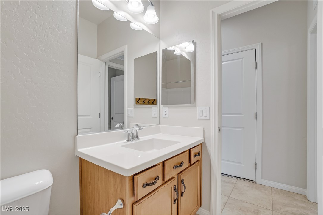 1145 Strada Pecei Henderson, NV 89011 - Photo 38 of 61 Half bathroom with vanity and tile patterned flooring