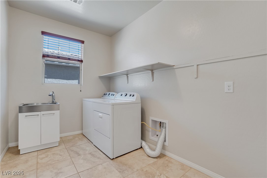 1145 Strada Pecei Henderson, NV 89011 - Photo 41 of 61 Laundry room with separate washer and dryer and light tile patterned floors