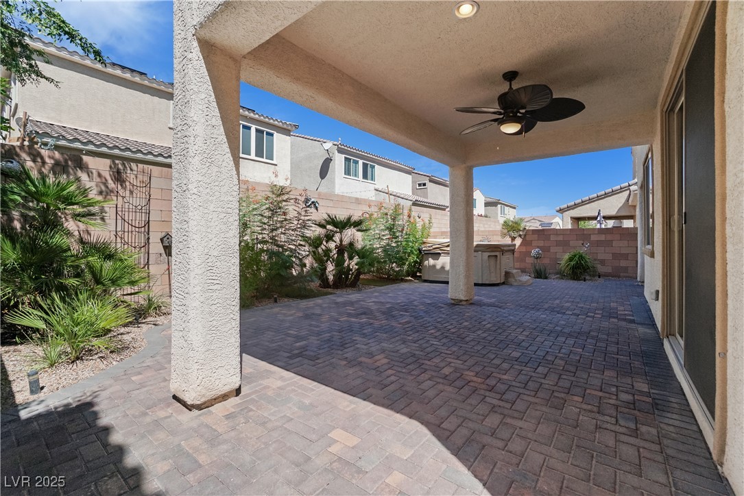 1145 Strada Pecei Henderson, NV 89011 - Photo 42 of 61 Fenced backyard with a patio area, a jacuzzi, and a ceiling fan