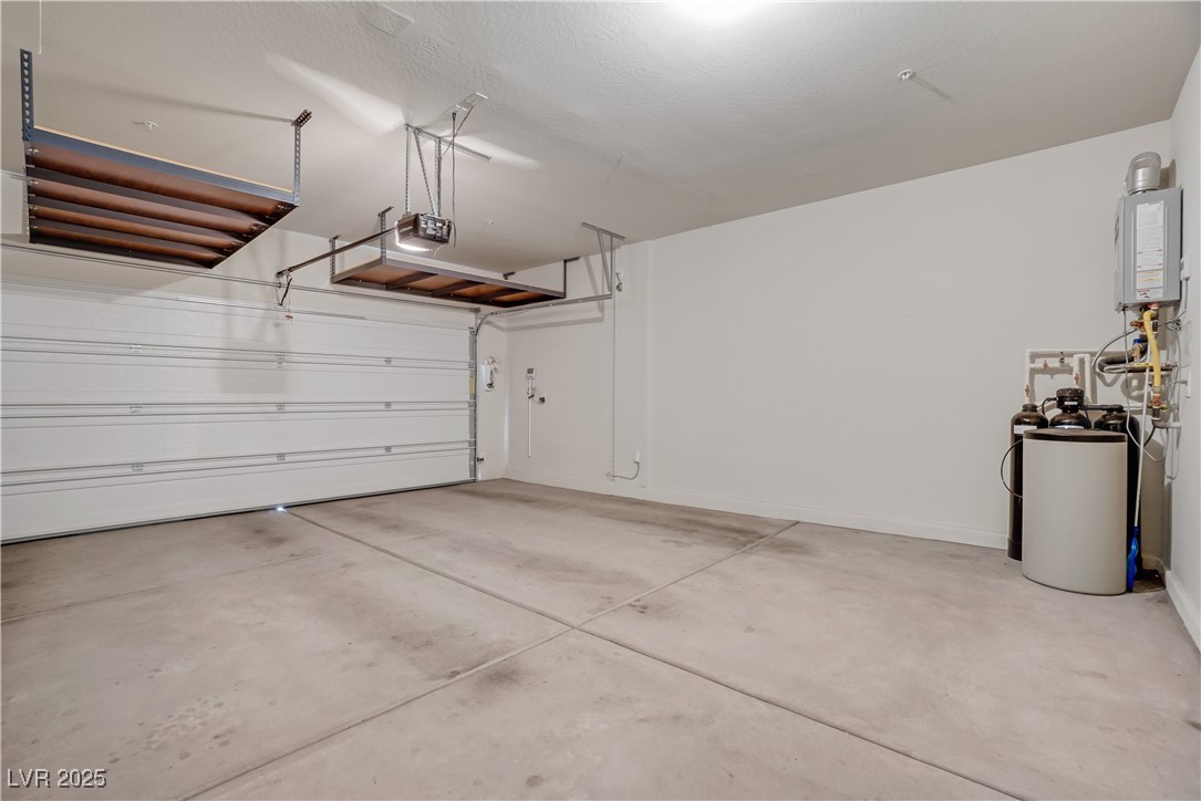 1145 Strada Pecei Henderson, NV 89011 - Photo 51 of 61 Garage featuring tankless water heater and a garage door opener