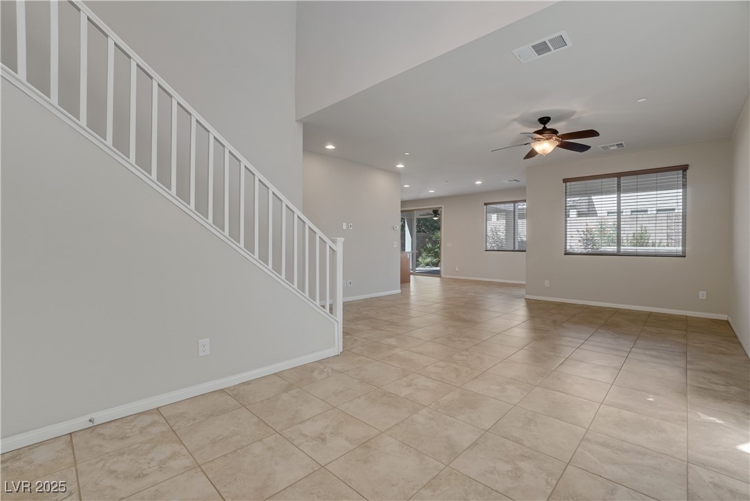 1145 Strada Pecei Henderson, NV 89011 - Photo 6 of 61 Unfurnished living room with recessed lighting, stairway, light tile patterned floors, and a ceiling fan