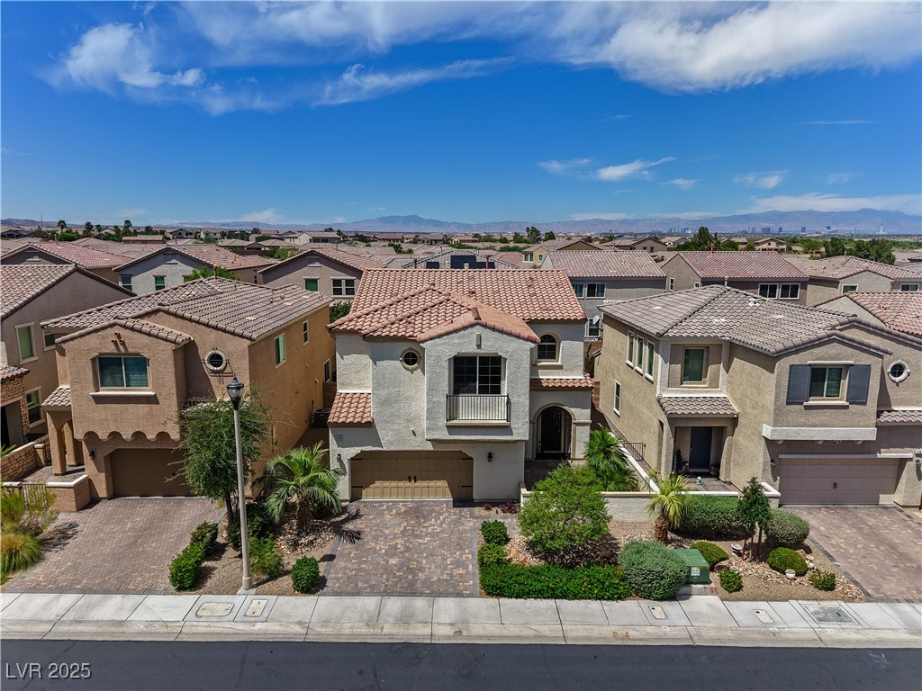 1145 Strada Pecei Henderson, NV 89011 - Photo 61 of 61 Mediterranean / spanish-style home featuring a residential view, a garage, driveway, and stucco siding