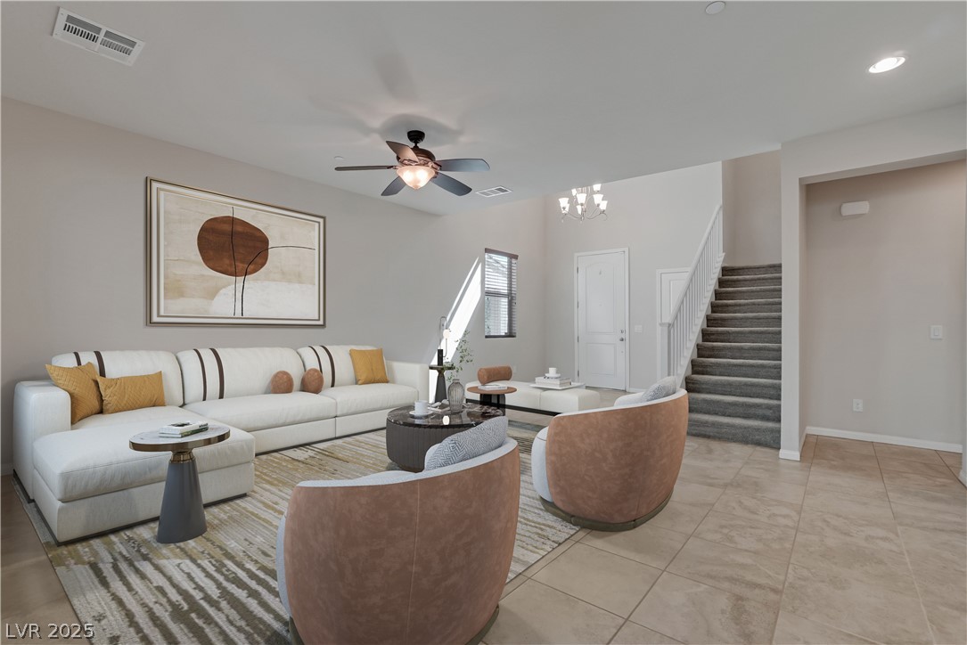 1145 Strada Pecei Henderson, NV 89011 - Photo 8 of 61 Living area featuring ceiling fan and a chandelier