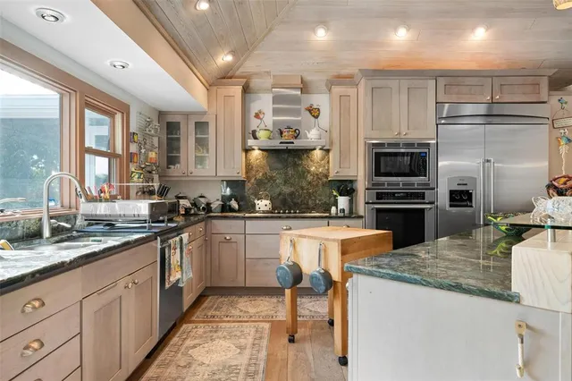 a bedroom with a bed and a flat tv screen on dresser