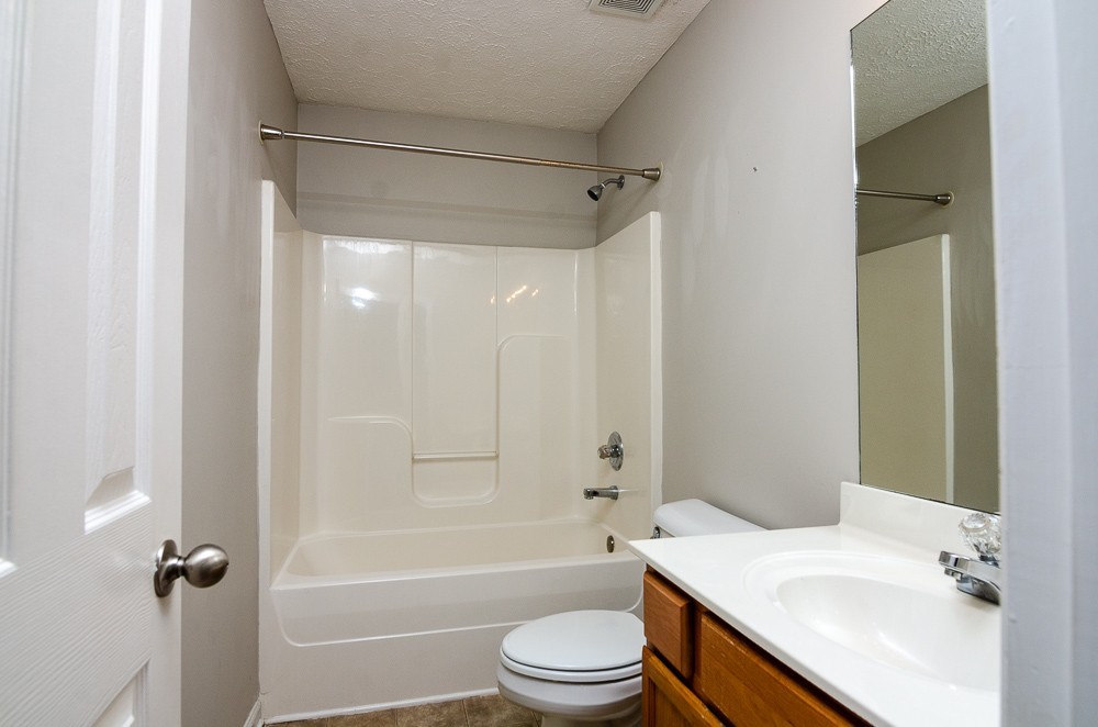 1912 Portview Drive Spring Hill, TN 37174 - Photo 12 of 20 a bathroom with a sink a toilet a mirror and a bathtub