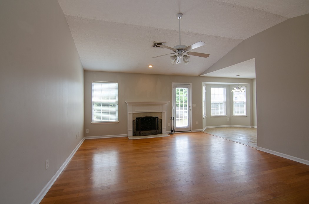 1912 Portview Drive Spring Hill, TN 37174 - Photo 3 of 20 an empty room with wooden floor fireplace and windows