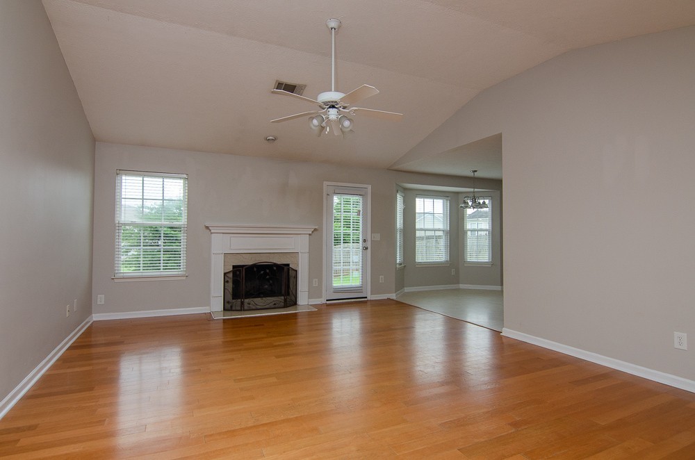 1912 Portview Drive Spring Hill, TN 37174 - Photo 5 of 20 an empty room with fireplace wooden floor and windows