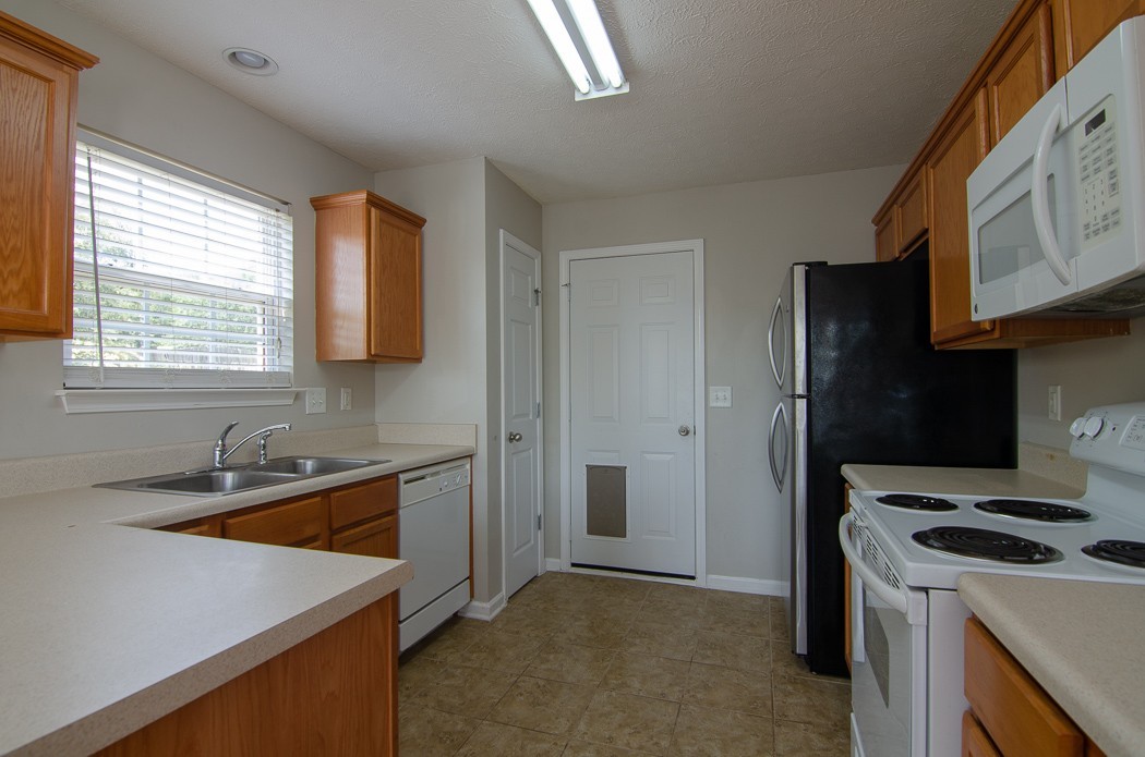 1912 Portview Drive Spring Hill, TN 37174 - Photo 8 of 20 a kitchen that has a sink a stove and a refrigerator
