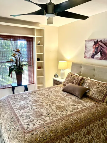 a bedroom with a large bed and a large window