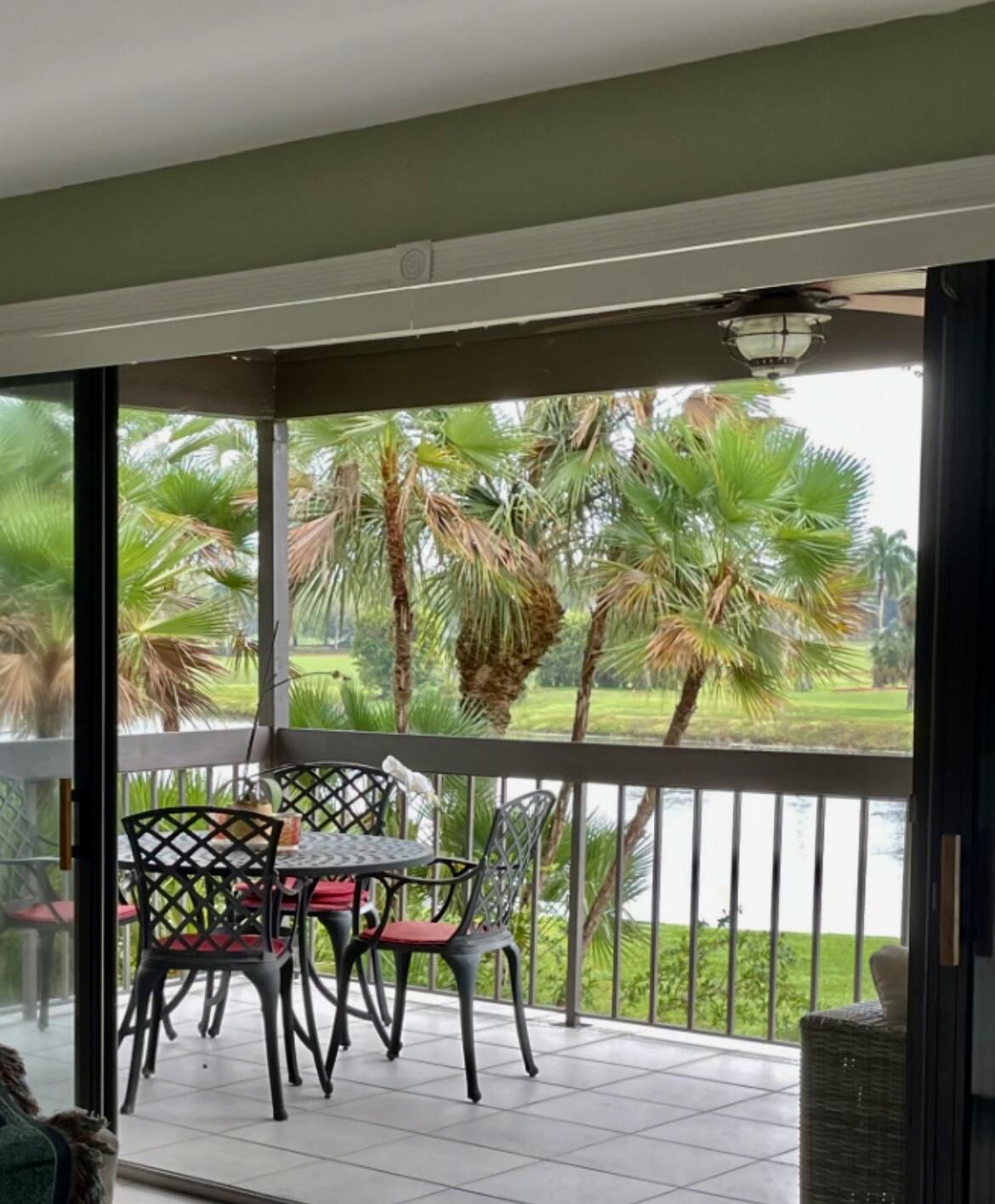 13321 Polo Club Road, Unit C 202 Wellington, FL 33414 - Photo 18 of 20 a view of a patio with a table chairs and a table