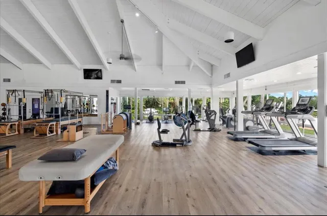 a living room with lots of furniture and gym equipment