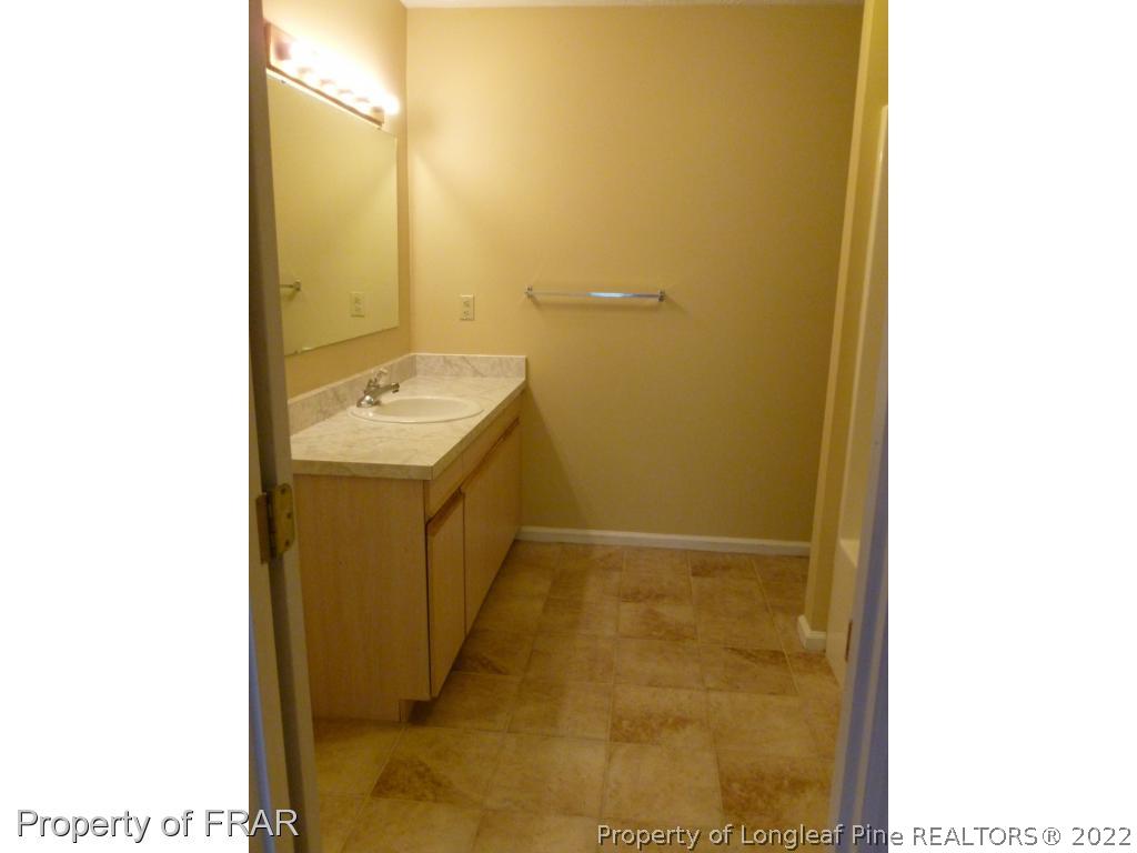 1813 Sardonyx Road Fayetteville, NC 28303 - Photo 14 of 25 a bathroom with a sink and a mirror